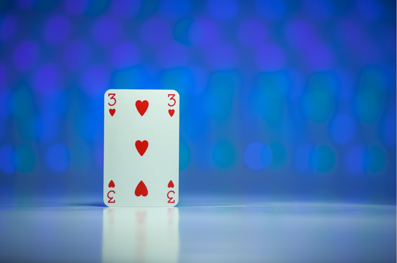 three of hearts on blue background