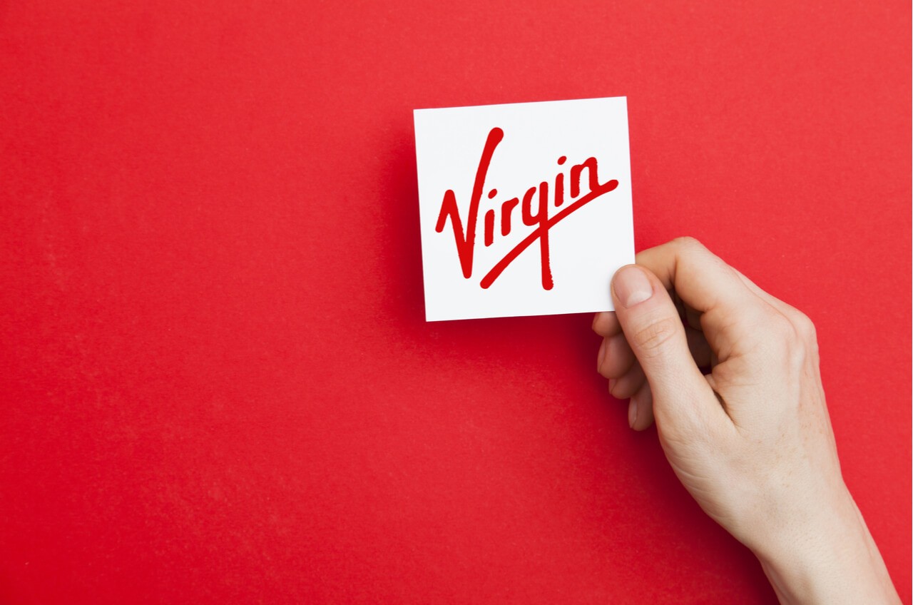 hand holding Virgin logo