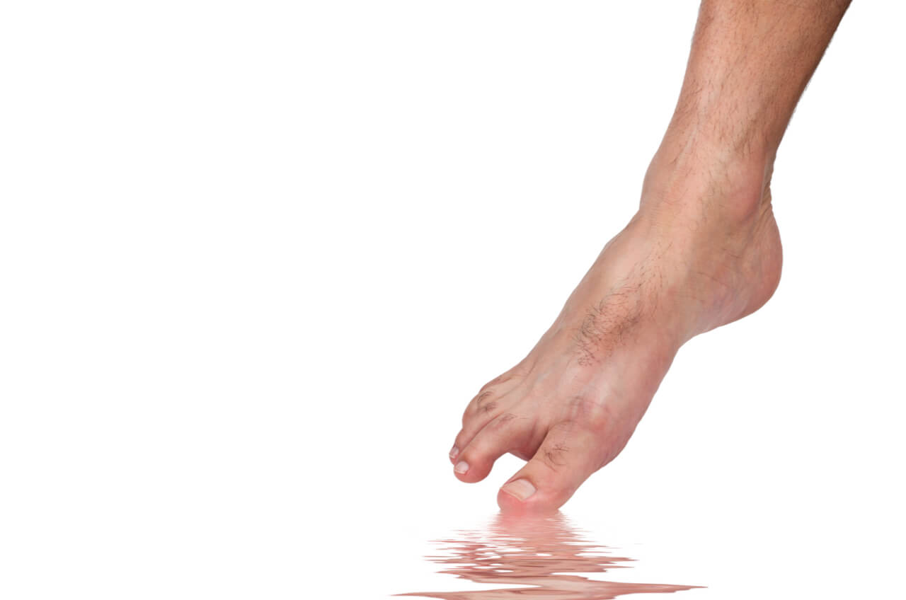 bare foot dipping toe in water