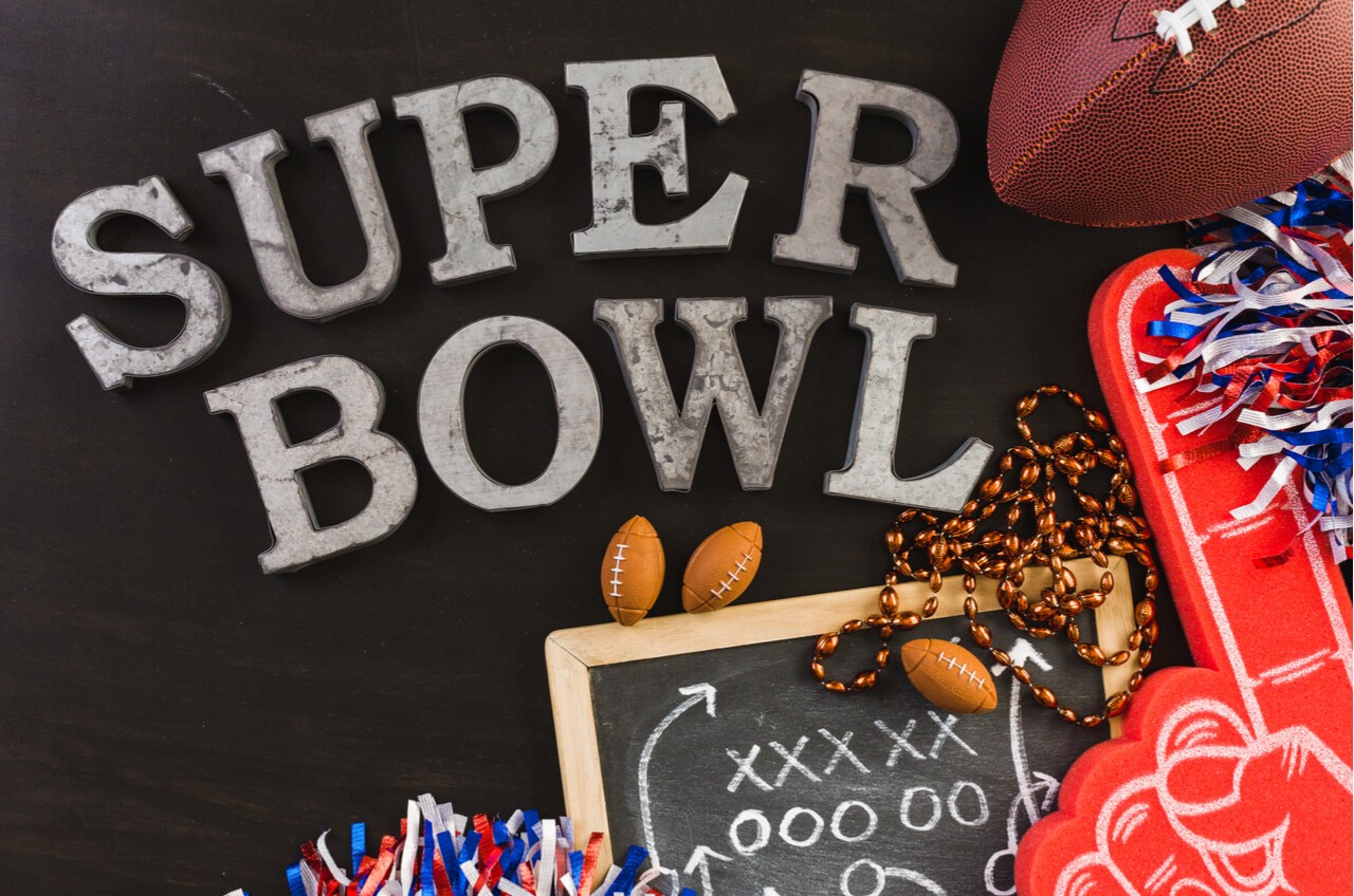 Super Bowl in chalk writing with football props