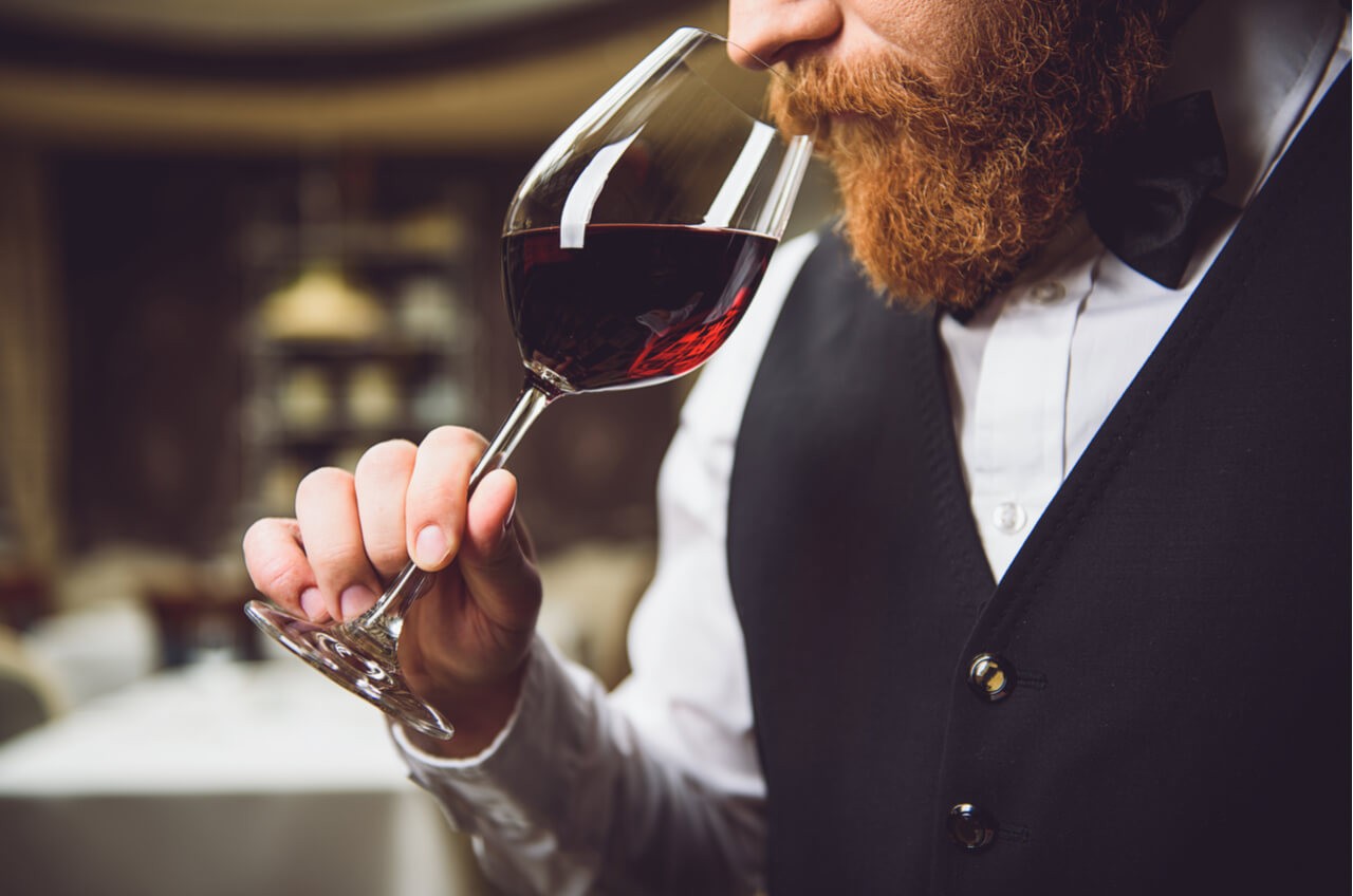 man snifing wine glass